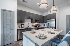 Chattanooga apartment for rent - A modern kitchen with a dining table set for two.