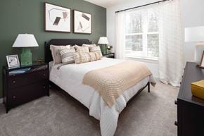 Acworth apartment for rent - 1-Bedroom Apartments in Acworth, GA - The Brookstone - Bedroom with Plush Carpeting, Bed, Nightstands with Drawers and Lamps, Dresser, and Large Window.