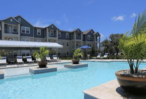 Ingleside apartment for rent - a large swimming pool with an apartment building in the background
