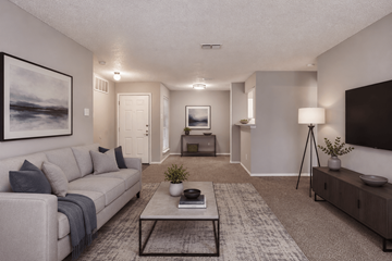 Dallas apartment for rent - A living room with a grey couch, a coffee table, and a painting on the wall.