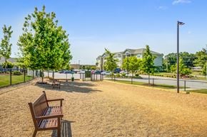 Easley apartment for rent - the preserve at ballantyne commons park benches in front of a playground and buildings