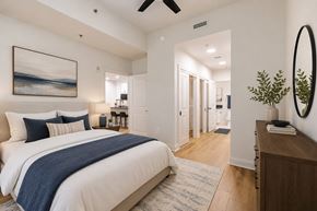 Atlanta apartment for rent - A bedroom with a large bed and a painting on the wall.