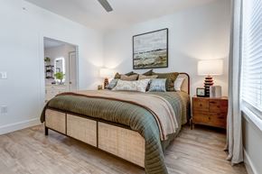 Summerville apartment for rent - A bedroom with a bed, nightstand, and a painting on the wall.
