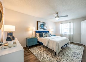Daytona apartment for rent - A bedroom with a bed, nightstand, and a ceiling fan.