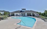 Mauldin apartment for rent - Apartments for Rent in Mauldin, SC - The Aster - An Outdoor Resort-Inspired Pool with Surrounding Lounge Seating in Front of The Resident Clubroom.