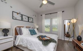 Mauldin apartment for rent - Apartments for Rent in Downtown Greenville, SC - The Aster - Bright Bedroom With White Bedding, Vinyl Plank Flooring, Ceiling Fan, Large Windows, and Modern Accent Lighting.