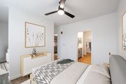 Rogers apartment for rent - a bedroom with a large bed and a ceiling fan