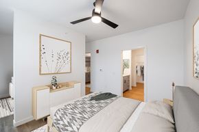 Rogers apartment for rent - a bedroom with a large bed and a ceiling fan