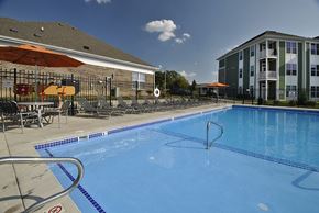 Wyoming apartment for rent - 1-Bedroom Apartments in Wyoming, MI - The Haven - Large Heated Outdoor Saltwater Swimming Pool Surrounded by Lounge Chairs and Umbrellas, Enclosed with a Fence, and Overlooking the Apartments.