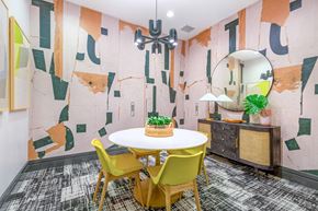 Rockville apartment for rent - a dining room with a white table and yellow chairs