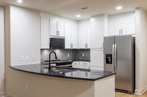 Atlanta apartment for rent - A kitchen with a black counter top and stainless steel appliances.