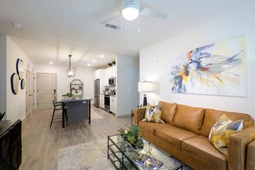 Snellville apartment for rent - A living room with a brown couch and a painting on the wall.