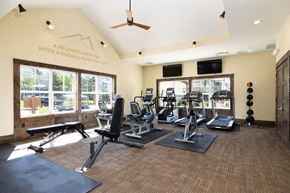 Woodland Park apartment for rent - A gym with a variety of equipment including treadmills, weights, and a bench.