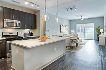 Atlanta apartment for rent - a kitchen with a large island and a living room with a table