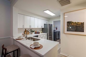 Tampa apartment for rent - A kitchen with white cabinets and a white counter top.