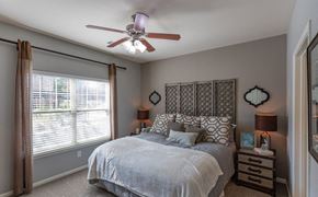 Gallatin apartment for rent - a bedroom with a bed and a ceiling fan