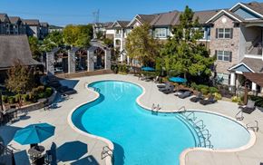 Gallatin apartment for rent - an aerial view of a swimming pool with umbrellas in front of a house