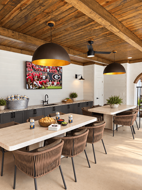 Atlanta apartment for rent - A modern dining room with a wooden ceiling and a large painting of a football game on the wall.