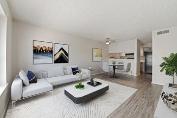 Odessa apartment for rent - A modern living room with a white sofa and a coffee table.