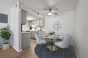 Odessa apartment for rent - A dining room with a table set for two and a plant in a white pot.