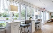 Tampa apartment for rent - A kitchen with white cabinets and a bar area with stools at Waterview at Rocky Point, Tampa, FL