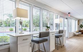 Tampa apartment for rent - A kitchen with white cabinets and a bar area with stools at Waterview at Rocky Point, Tampa, FL