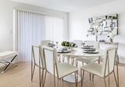 Tampa apartment for rent - A modern dining room with a white table and chairs at Waterview at Rocky Point, Tampa, FL