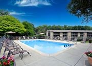 Kalamazoo apartment for rent - A pool surrounded by chairs and trees at Winchell Way Apartment , Kalamazoo, 49008