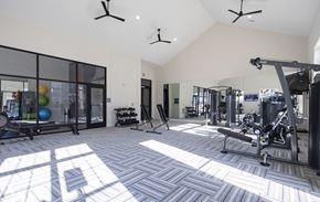 Huntsville apartment for rent - a gym with weights and other equipment in a building with windows