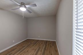 Sandy Springs apartment for rent - A room with a ceiling fan and wooden flooring.