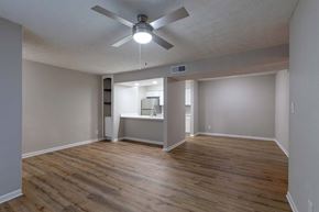 Sandy Springs apartment for rent - A room with a ceiling fan and wooden flooring.