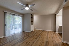 Sandy Springs apartment for rent - A room with a ceiling fan and wooden flooring.