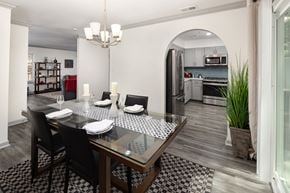 Atlanta apartment for rent - A modern dining room with a glass table and chairs.