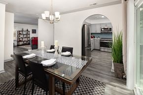 Atlanta apartment for rent - A modern dining room with a glass table and chairs.