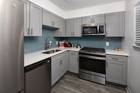 Atlanta apartment for rent - A kitchen with a stainless steel refrigerator, microwave, oven, and dishwasher.