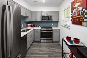 Atlanta apartment for rent - A modern kitchen with a refrigerator, microwave, oven, and dishwasher.