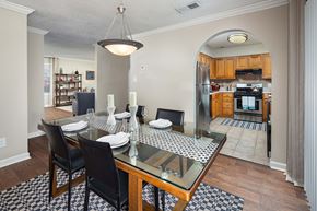 Atlanta apartment for rent - A dining room with a glass table and chairs.