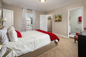 Atlanta apartment for rent - A bedroom with a large bed and a chair.