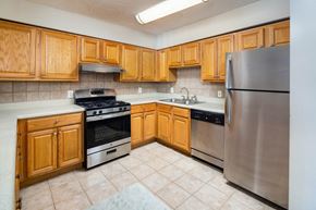 Atlanta apartment for rent - A kitchen with wooden cabinets and stainless steel appliances.