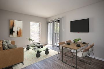 Charlotte apartment for rent - A living room with a brown couch, a glass coffee table, a dining table with chairs, and a painting on the wall.