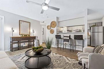Norcross apartment for rent - A living room with a black coffee table and a framed picture on the wall.