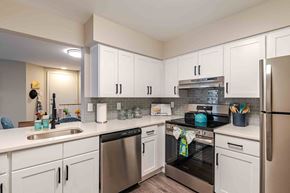 Lorton apartment for rent - A kitchen with white cabinets and stainless steel appliances.