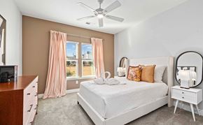 Fort Walton Beach apartment for rent - A bedroom with a large bed, a dresser, and a ceiling fan.