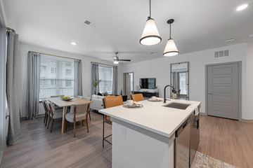 Chattanooga apartment for rent - an open kitchen and living room with a dining room table and chairs and an island