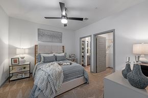 Chattanooga apartment for rent - 3-Bedroom Apartments in Chattanooga, TN - Populus Waterside - Carpeted Bedroom with Large Bed, Nightstands, Lamps, Private Bathroom, Spacious Closet, and Ceiling Fan.