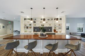 Miami apartment for rent - a dining room with a table and chairs in front of a kitchen