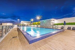 Miami apartment for rent - a swimming pool on the rooftop of a hotel at night