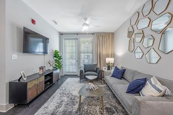 Wood-like flooring in foyer, kitchen, and living rooms