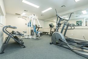 North Chesterfield apartment for rent - A gym with a variety of equipment including a treadmill, stationary bike, and weight bench.