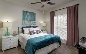 Alpharetta apartment for rent - a bedroom with a bed and a ceiling fan
